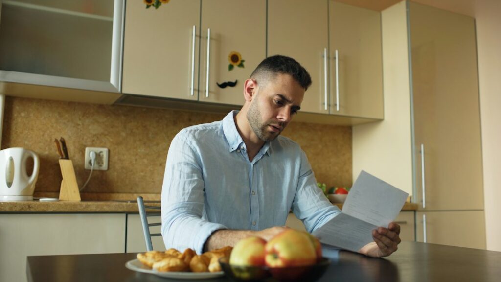 Property owner and manager review a lease, inspection checklist, and maintenance records at a table.