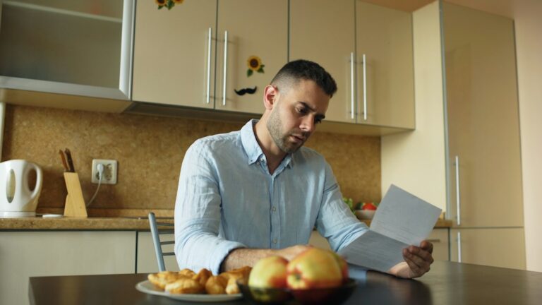 Property owner and manager review a lease, inspection checklist, and maintenance records at a table.
